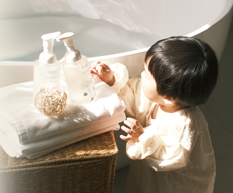 Child beside PURELU Baby care products prepared for bath time