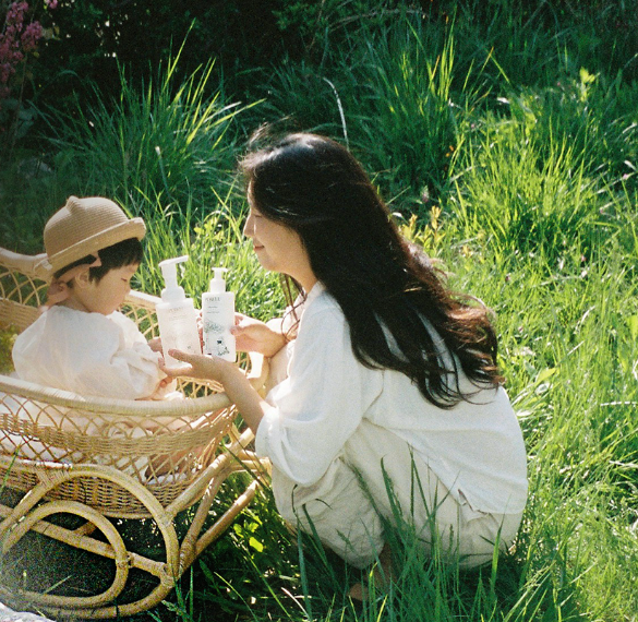 Parent and child sharing an outdoor moment with PURELU care products