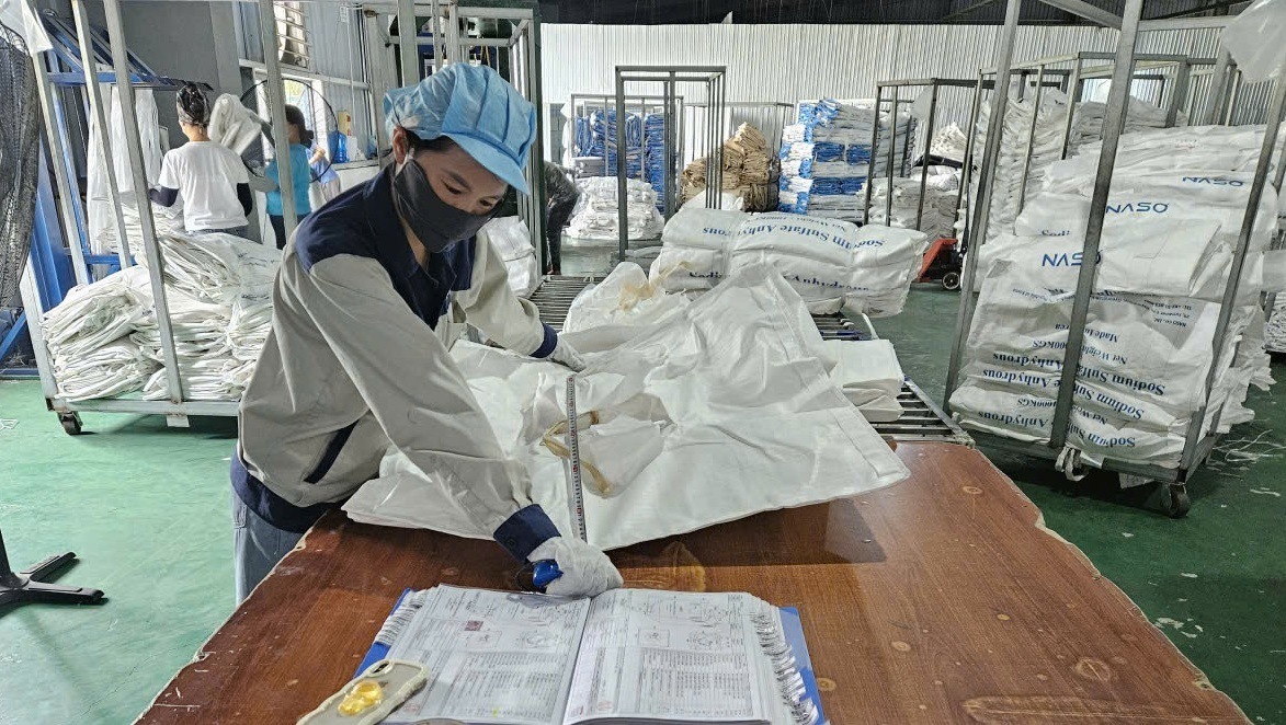Inspector checking a bag alongside an inspection sheet