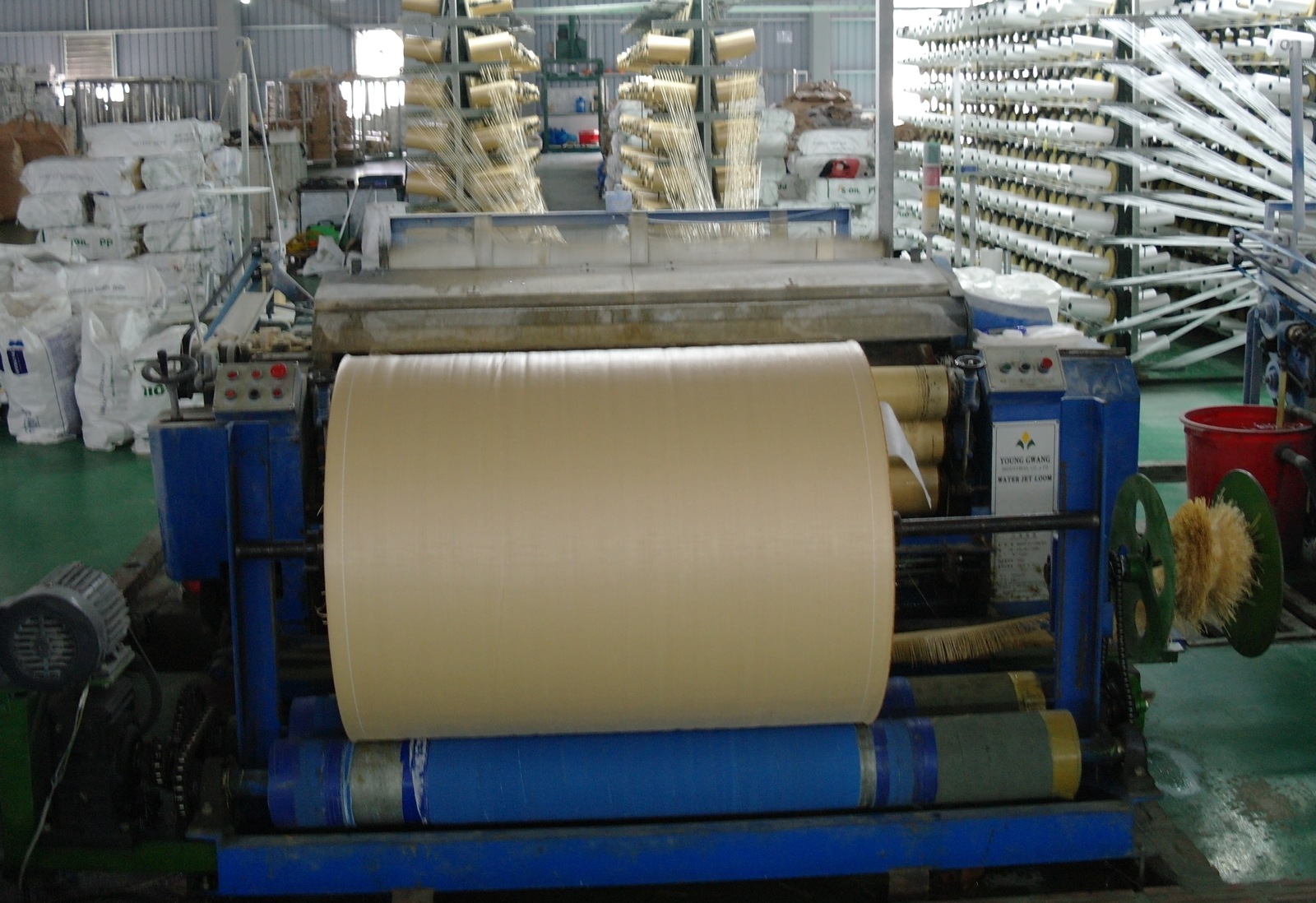 Woven fabric being collected on a roll